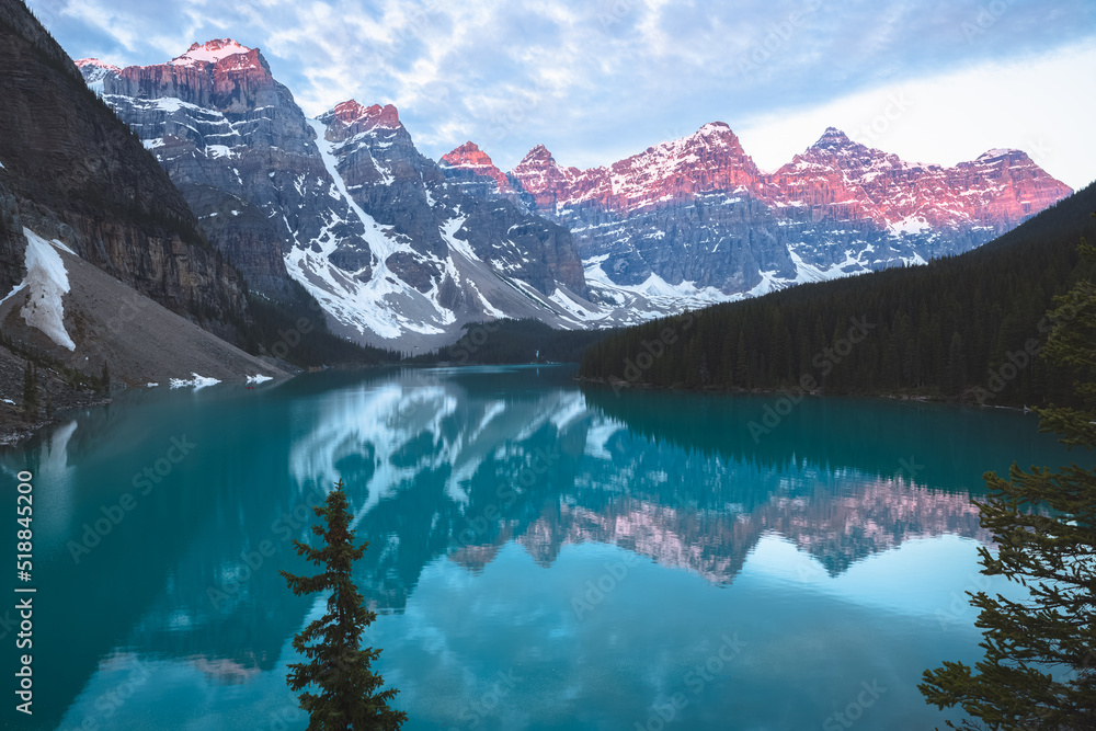Scenic sunset or sunrise view of glacial Moraine Lake landscape, a popular tourist destination in Banff National Park, Alberta, Canada in the Rocky Mountains.