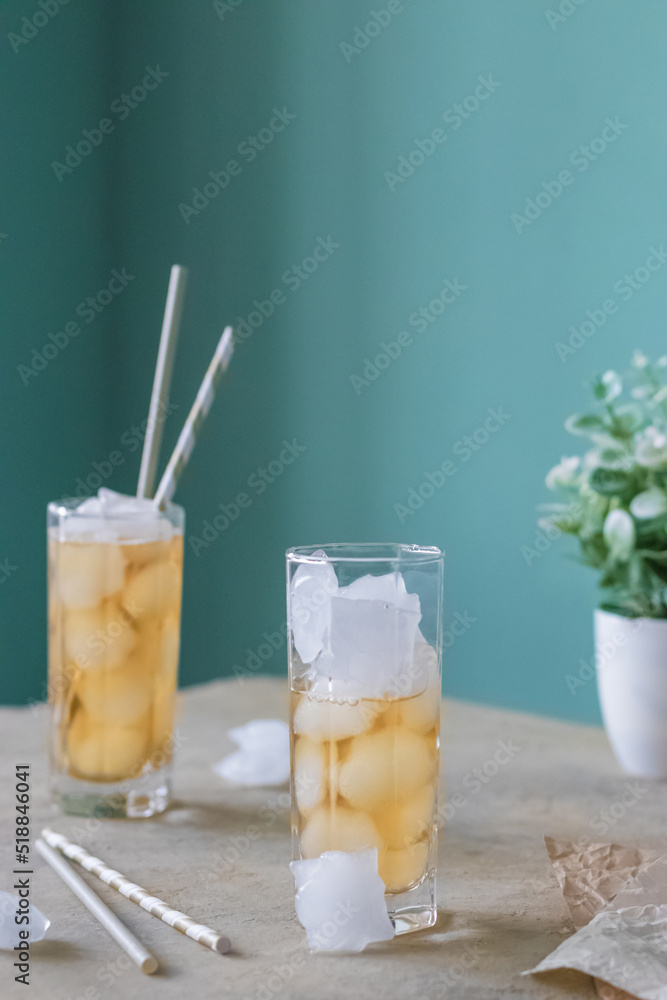 Fototapeta premium Delicious green tea with ice on the table. Refreshing summer drink. Natural product.