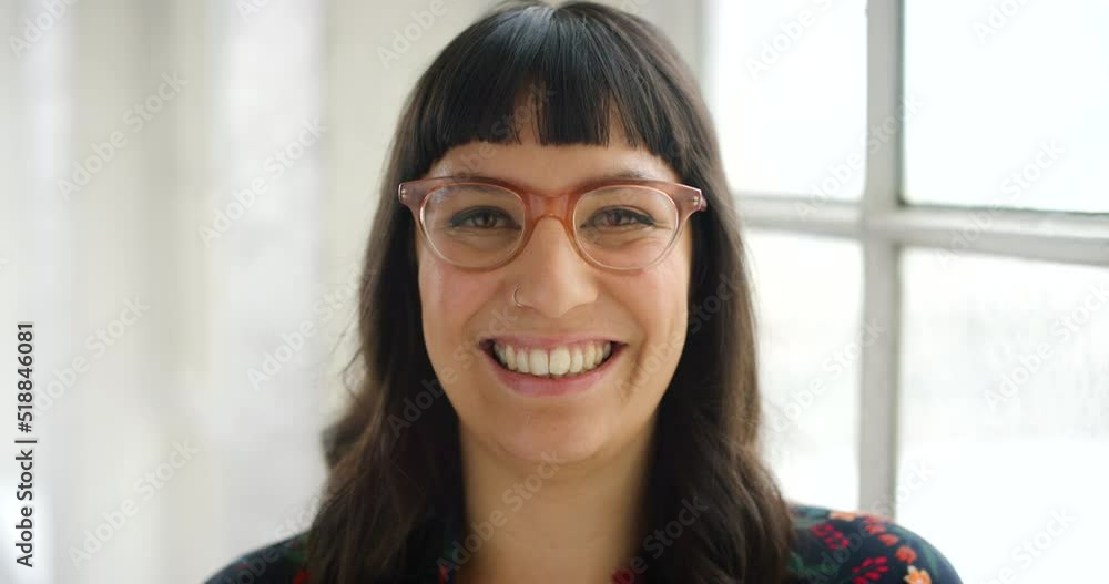 A happy face of a female office worker or IT professional. A motivated modern business woman feeling cheerful in the workplace. Portrait of a smiling woman wearing trendy, hipster glasses. A happy face of a female office worker or IT professional. A motivated modern business woman feeling cheerful in the workplace. Portrait of a smiling woman wearing trendy, hipster glasses.