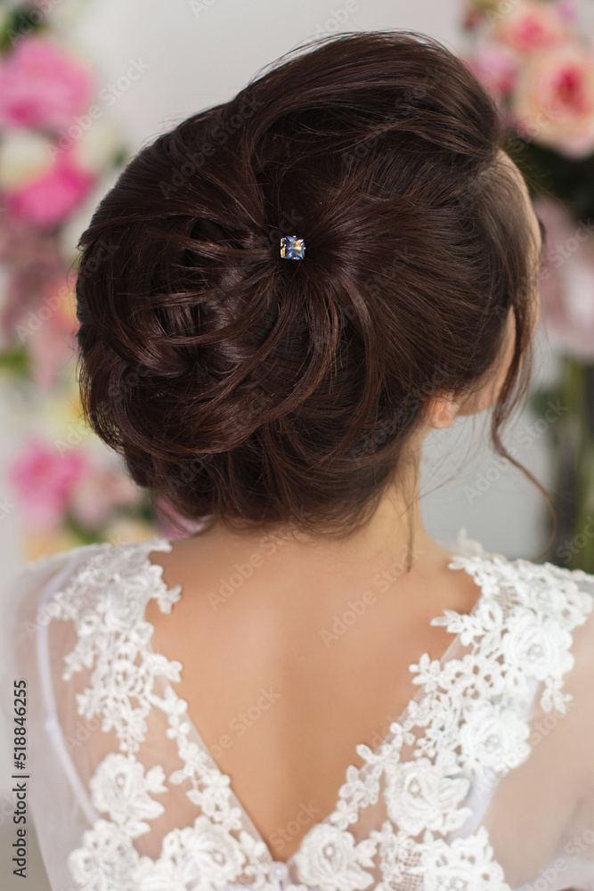 
Beautiful bride back with elegant wedding hair style, dress and flowers