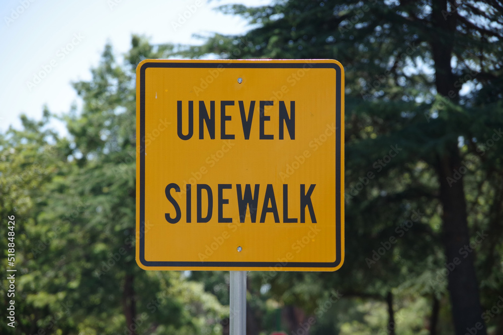Warning sign UNEVEN SIDEWALK