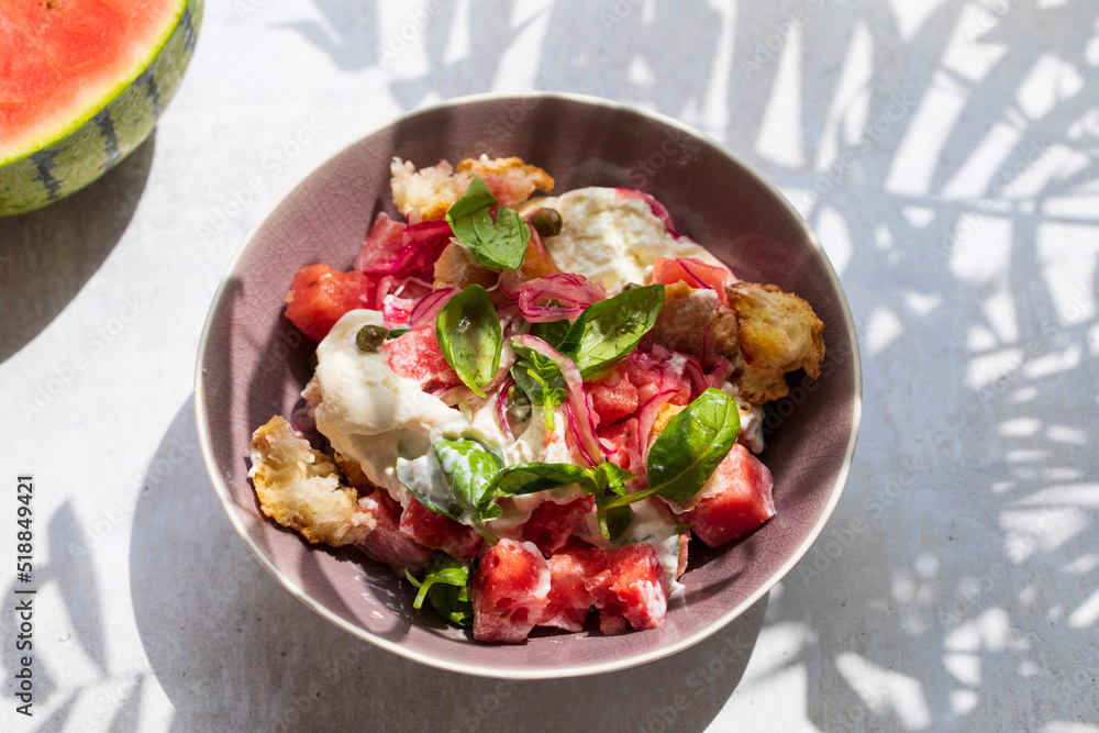 Summer salad with watermelon, buratta, basil and pickled onions Summer salad with watermelon, buratta, basil and pickled onions