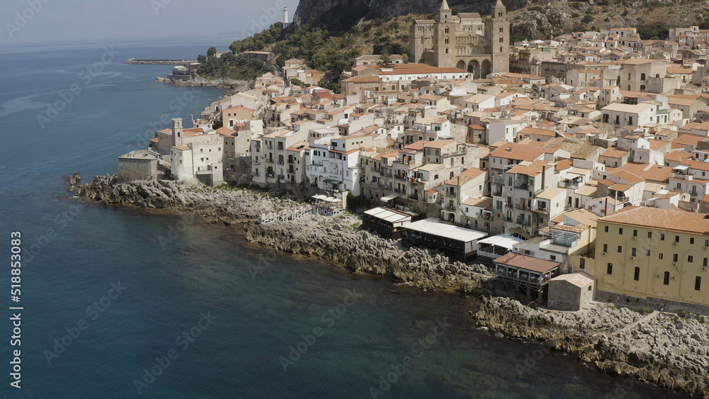 Aerial view of the stony coast, azure sea, and the European city in Italy. Action. Travel and holyday concept, beautiful houses near the sea.