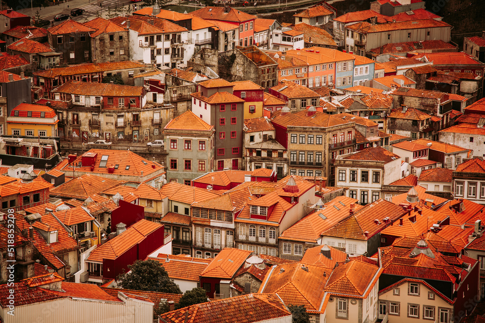Old historical buildings with orange roofs in Porto city, seen from Clerigos Tower, part of Church of the Clergymen, Portugal