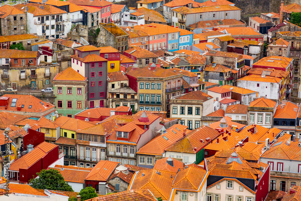 Old historical buildings with orange roofs in Porto city, seen from Clerigos Tower, part of Church of the Clergymen, Portugal