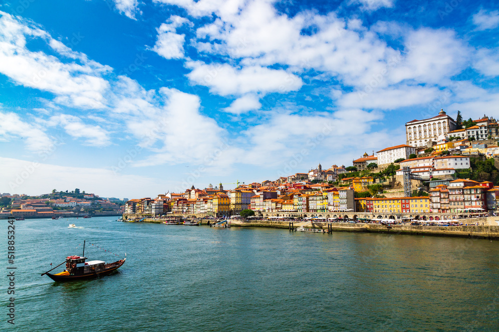 Porto, Portugal old town cityscape and the Douro River with traditional Rabelo boats