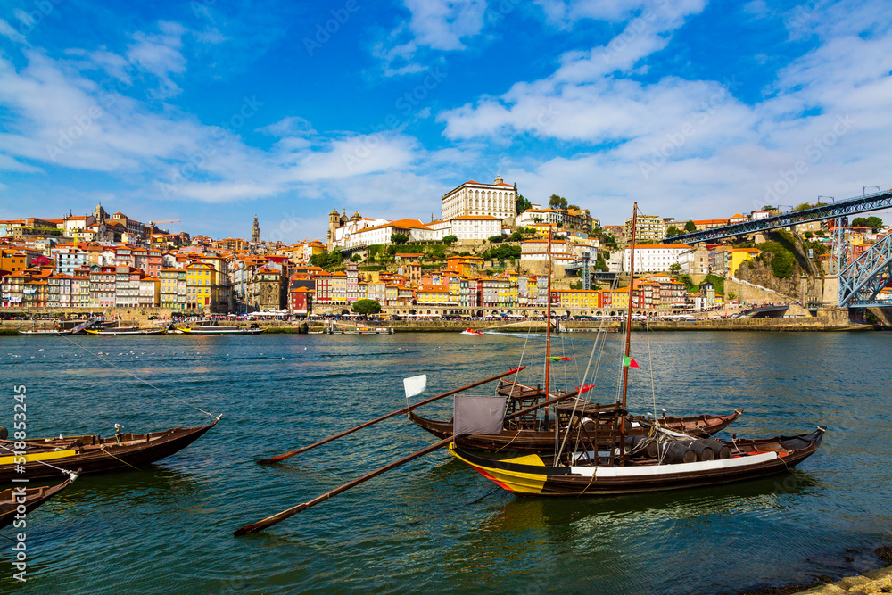 Porto, Portugal, Riberia old town cityscape and the Douro River with traditional Rabelo boats