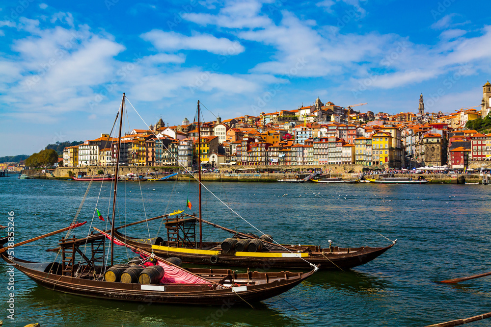 Porto, Portugal, Riberia old town cityscape and the Douro River with traditional Rabelo boats