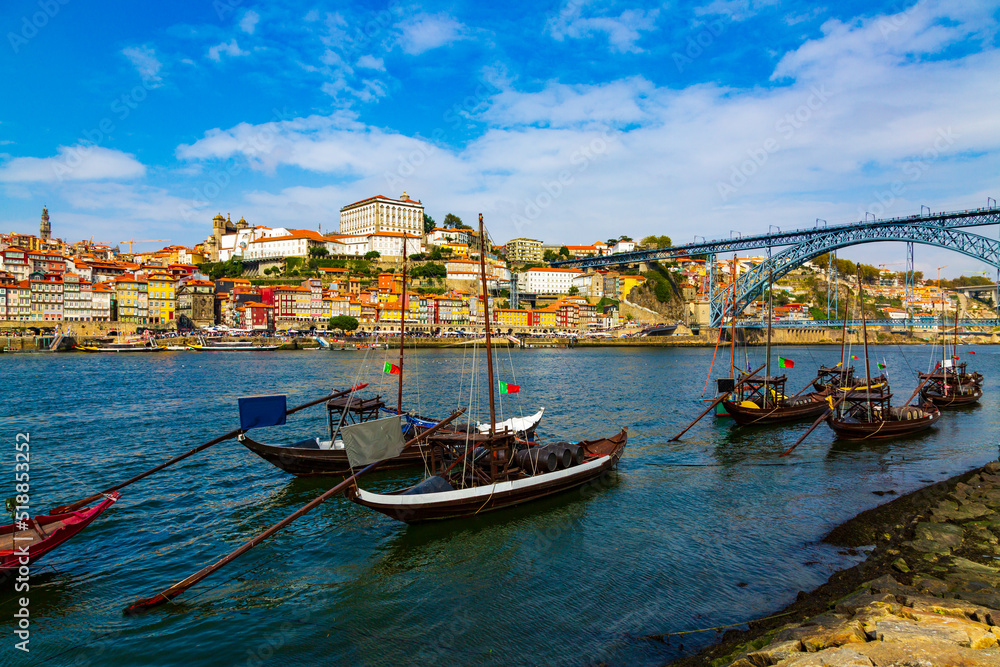 Fototapeta premium Porto, Portugal, Riberia old town cityscape with Dom Lusi bridge and the Douro River with traditional Rabelo boats