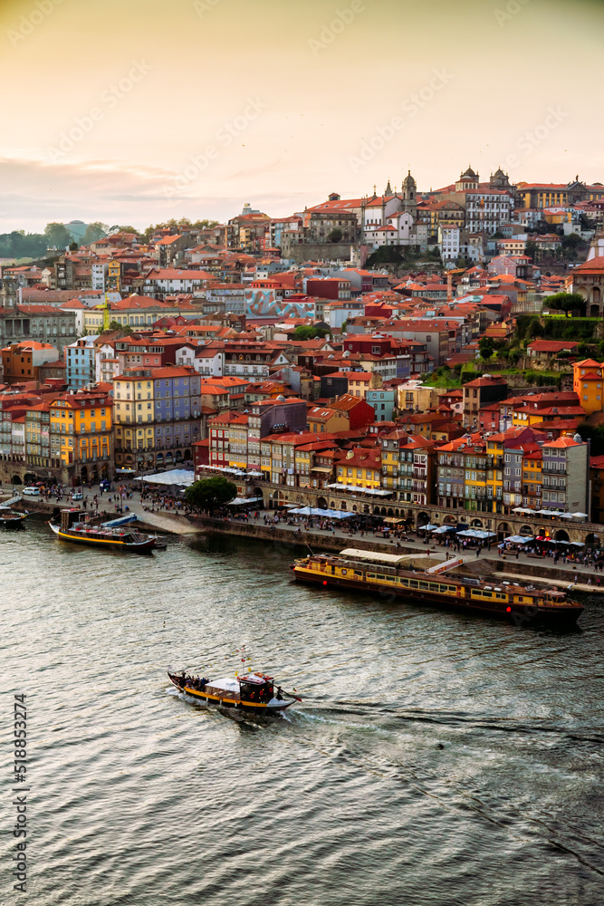 Porto, Portugal, old town cityscape and the Douro River with traditional Rabelo boats, seen from the Dom Luis bridge