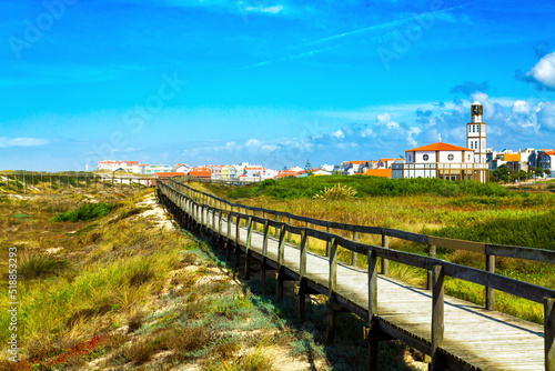 Costa Nova, Portugal: wooden path located on Atlantic Ocean dunes and wooden coast buildings near Aveiro.