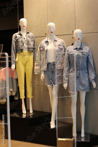 A mannequin stands on a showcase in a store.