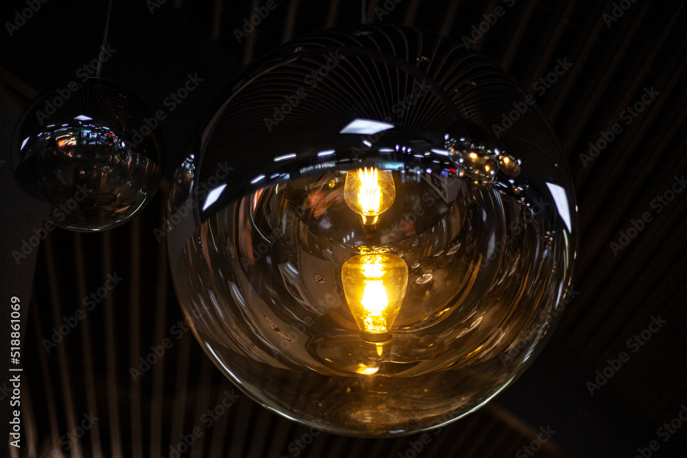 Fancy lamps on the ceiling. Glowing balls. Indoor lighting design. Spherical transparent containers for diffusing light. Fancy lamps on the ceiling. Glowing balls. Indoor lighting design. Spherical transparent containers for diffusing light.
