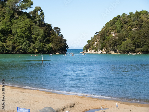 People enjoying summer at golden Bay Beach, sunbathing and swimming photo