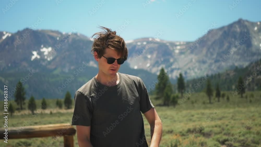 Caucasian man casually shoots a handgun sideways and the casing flies away in slow motion