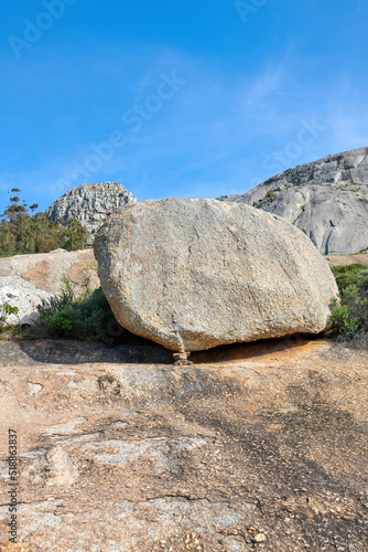 Big rocks on a mountain with a blue sky background and copy space. Large stones with beautiful rough texture details on a sunny day. Closeup outdoor nature landscape of boulders on a rocky hill
