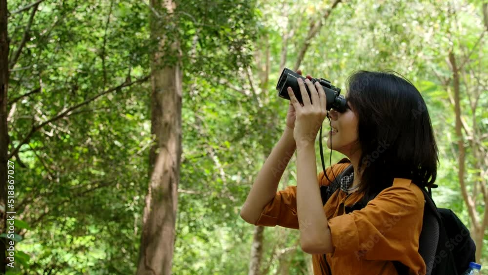 Close up Young tourist use nature binoculars to see wildlife the forest . Beautiful Young Woman Looking Through Binoculars Close up Young tourist use nature binoculars to see wildlife the forest . Beautiful Young Woman Looking Through Binoculars