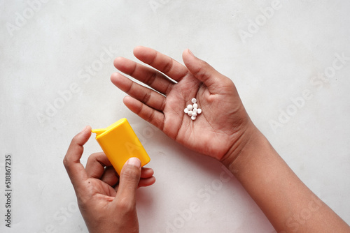 artificial sweetener container on hand on white background 