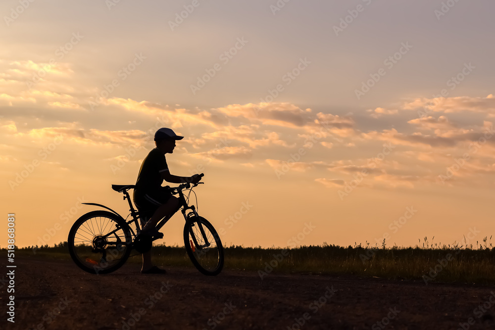 boy on bicycles. summer healthy lifestyle. sunset holidays. copy space.