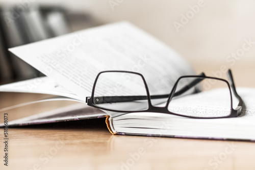 an open book and glasses. Selective focus. news, knowledge. Copy space © PanArt