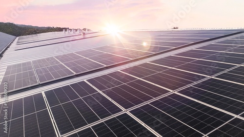 Photovoltaic solar panels mounted on building roof for producing clean ecological electricity at sunset. Production of renewable energy concept.with sunset view.