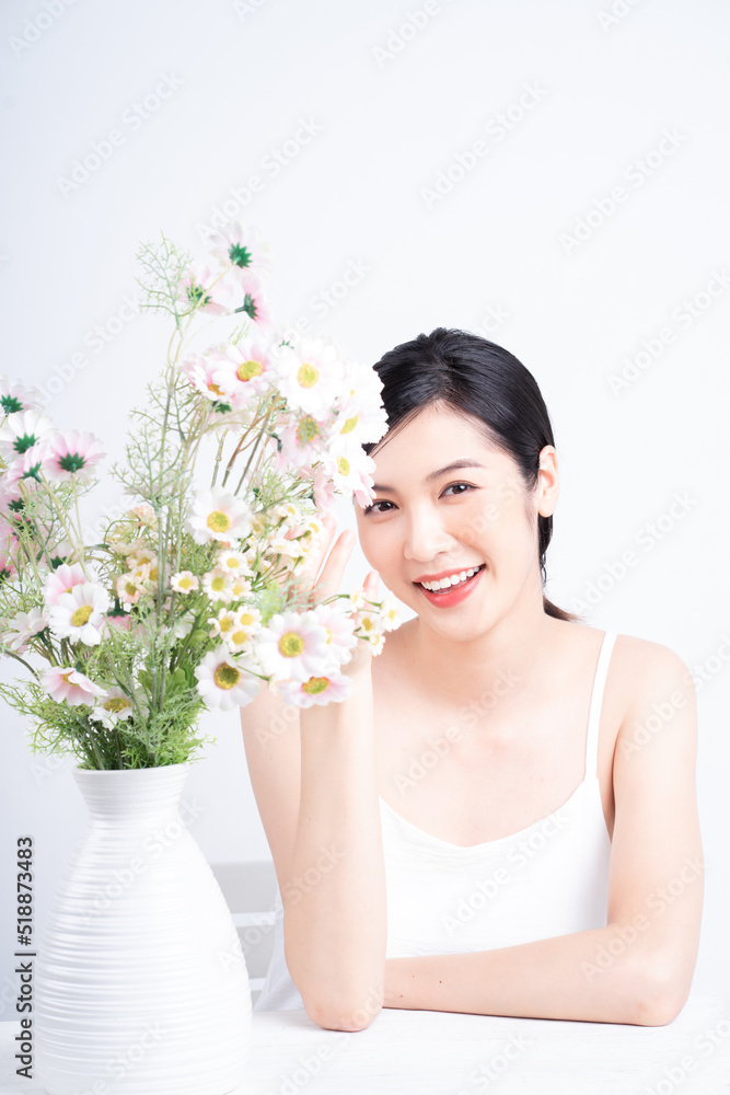 Beauty image of young Asian woman with flowers Beauty image of young Asian woman with flowers
