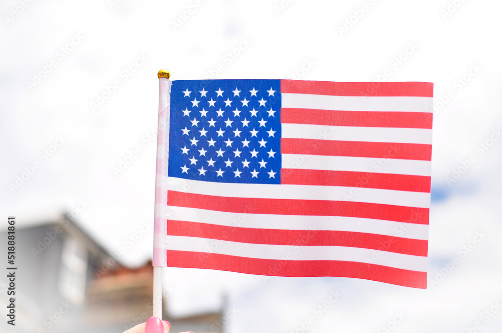 Obraz premium Close up of national flag of USA stripes and stars red and blue colors