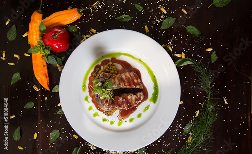 Typical dish of Peru, alpaca loin on a restaurant table.