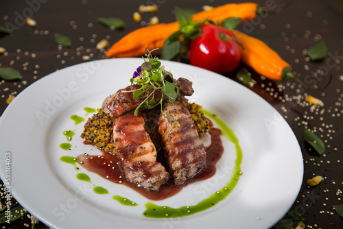 Typical dish of Peru, alpaca loin on a restaurant table.