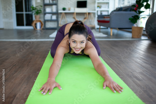 young asian woman working out and doing yoga at home, healthy concept.