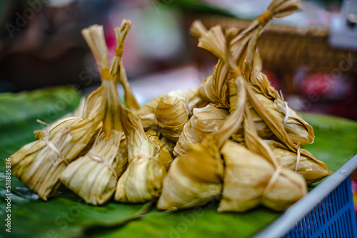 Glutinous rice mixed with sugar bean paste, wrapped in saffron leaves and steamed called Khao Tom Hang, is sold at Ban Chak Ngaew Chinese Community Market, Thailand.