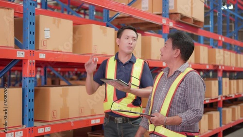 Professional, Two asian male warehouse worker holding tablet and discuss checking stock, counting Inventory in retail warehouse of shelf. Employee working in Factory or Distribution logistics center.