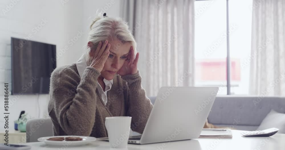 Tired senior woman with a headache looking at laptop screen sitting at desk feeling unhappy. Frustrated mature businesswoman made mistake in work, has issues with project. Stressing working from home Tired senior woman with a headache looking at laptop screen sitting at desk feeling unhappy. Frustrated mature businesswoman made mistake in work, has issues with project. Stressing working from home