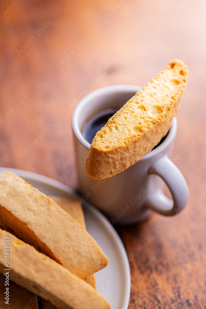 Sweet anicini cookies. Italian biscotti with anise flavor and coffee cup on wooden table. Sweet anicini cookies. Italian biscotti with anise flavor and coffee cup on wooden table.
