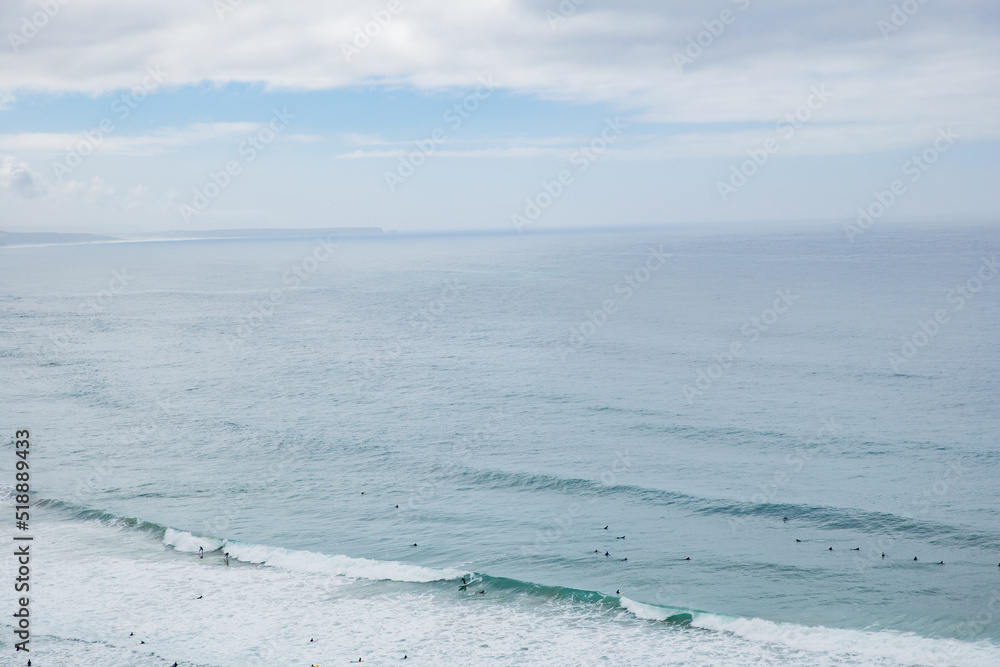 Aerial view of group of surfers in the ocean waiting for the waves Aerial view of group of surfers in the ocean waiting for the waves