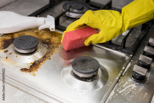dirty kitchen stove, empty and full bottles of detergents around.