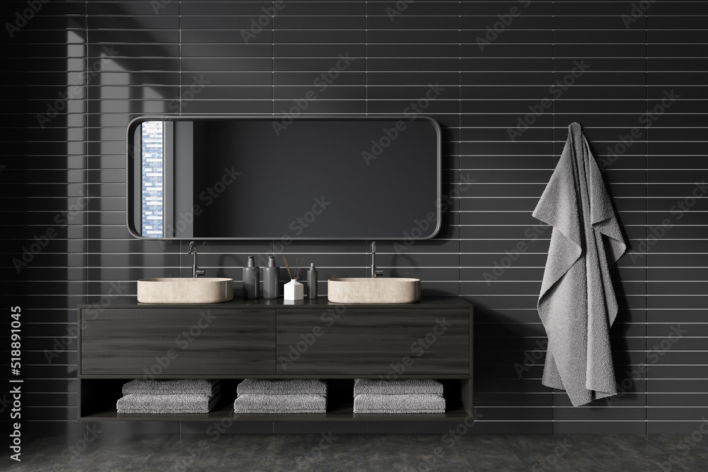 Front view on dark bathroom interior with large mirror Front view on dark bathroom interior with large mirror