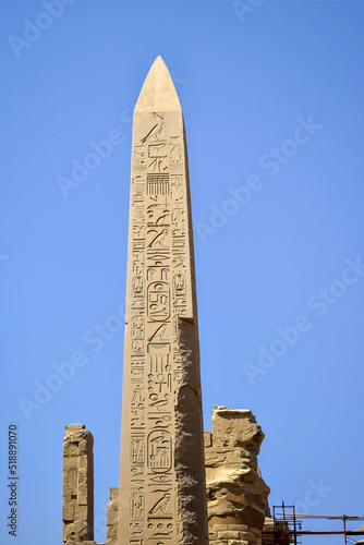 Tall pillar with carved ancient hieroglyphs in Karnak Temple complex. Legacy of past centuries, heritage. Luxor, Egypt. Copy space.