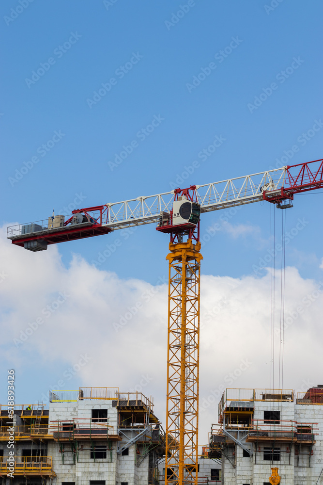 A crane in the middle to move construction materials, to a building under construction. The new Ahismach