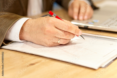 close up of a person writing on a notebook