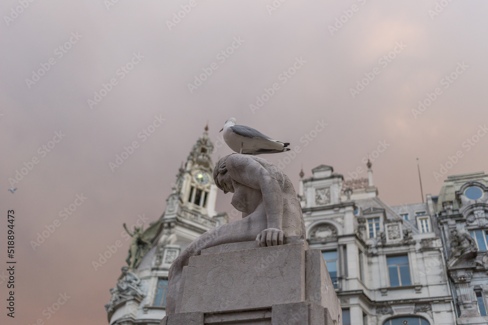 Fototapeta premium A seagull sitting on a statue in Porto, Portugal