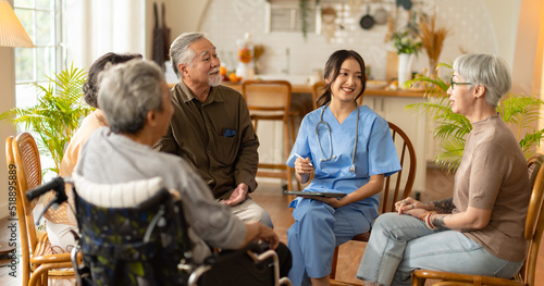 Group of asian senior people listening to young nurse.Psychological support group for elderly therapy session in a community centre. Group therapy in session sitting in a circle in a nursing home. photo