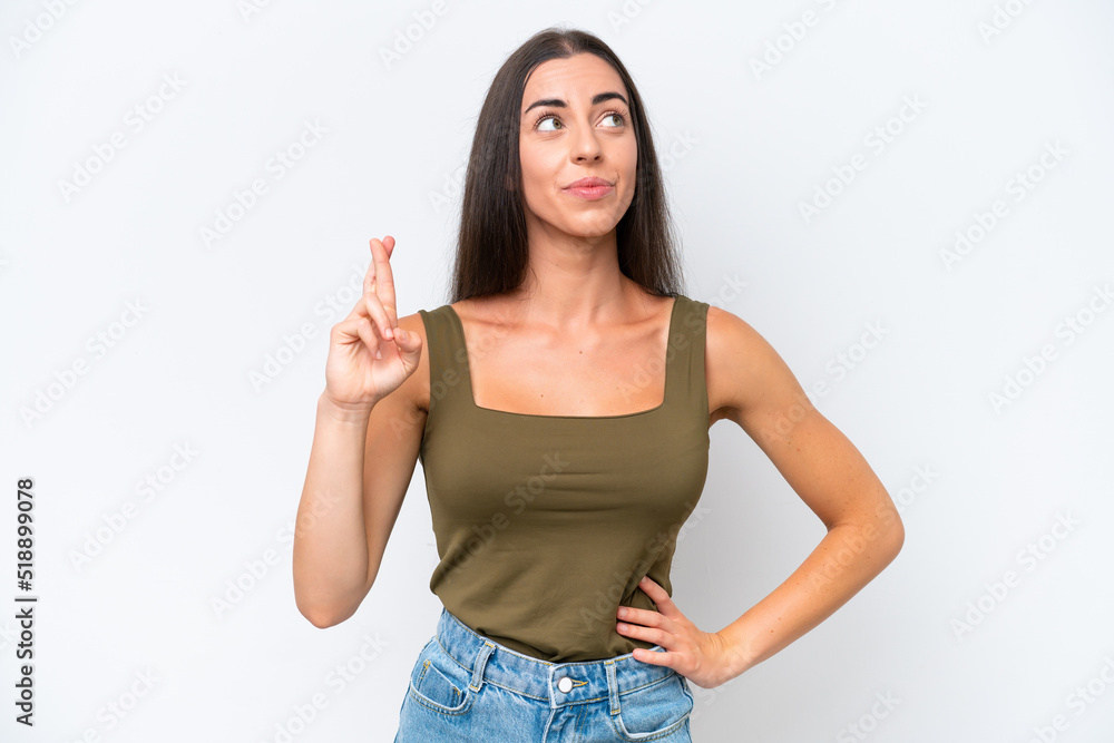 Young caucasian woman isolated on white background with fingers crossing and wishing the best Young caucasian woman isolated on white background with fingers crossing and wishing the best