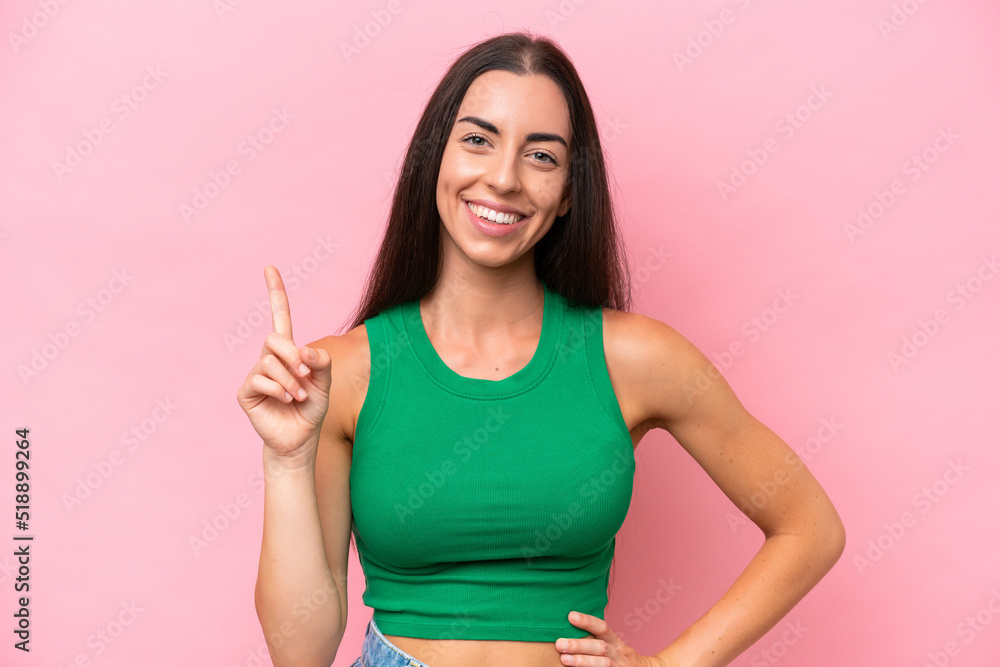 Young caucasian woman isolated on pink background showing and lifting a finger in sign of the best Young caucasian woman isolated on pink background showing and lifting a finger in sign of the best