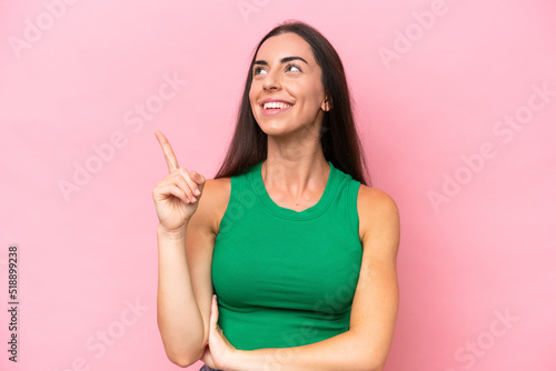 Young caucasian woman isolated on pink background pointing up a great idea © luismolinero