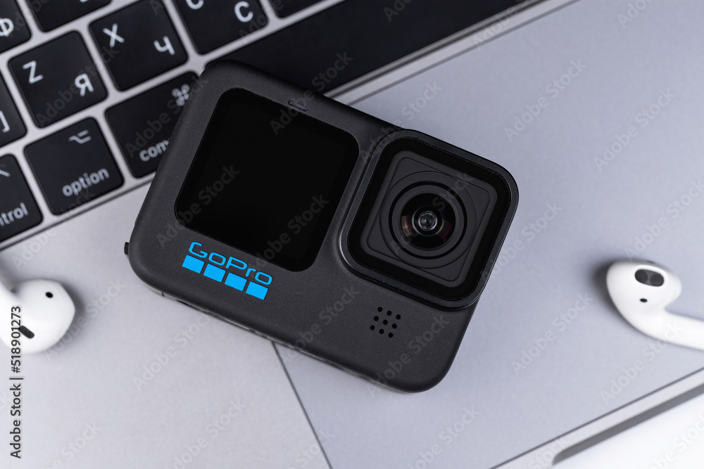 Action camera GoPro Hero 10 black with notebook Macbook closeup. GoPro Inc.  is an American company that manufactures action cameras and accessories for  them. Batumi, Georgia - July 11, 2022 Photos | Adobe Stock
