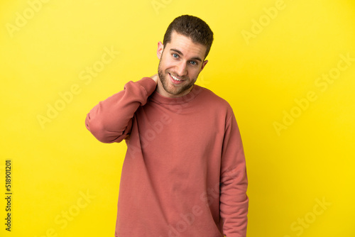 Handsome blonde man over isolated yellow background laughing