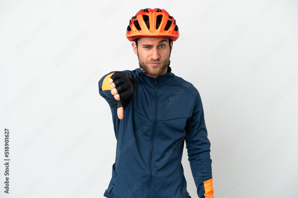 Young cyclist man isolated on white background showing thumb down with negative expression Young cyclist man isolated on white background showing thumb down with negative expression