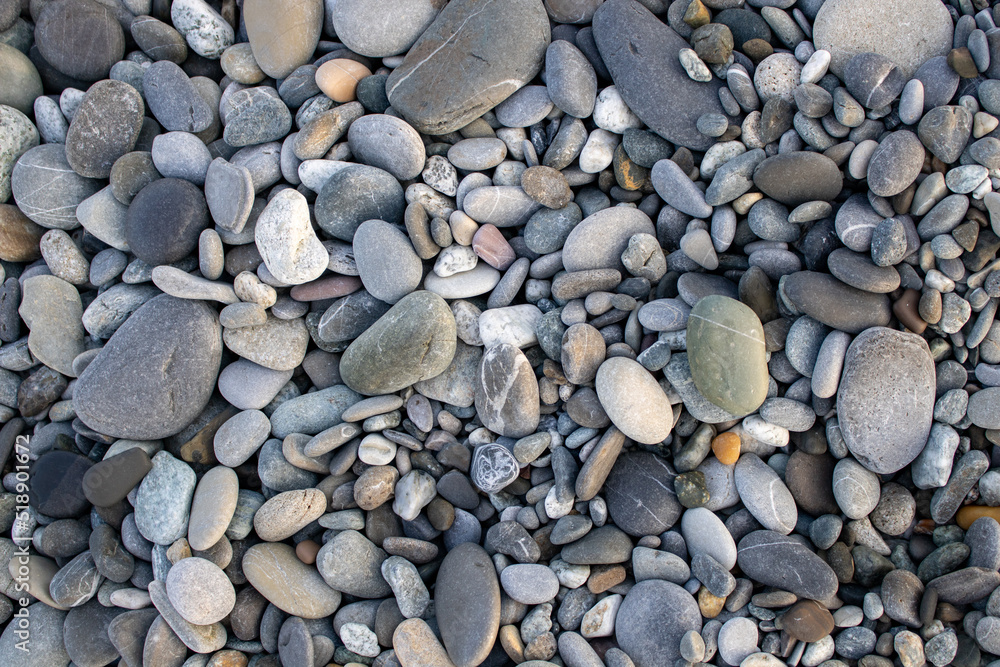 Pebble beach at Adriatic coast in Montenegro. Waves of clear water on clean beach of marble pebbles. Resort beach travel background with nobody and copy space. Pebble beach at Adriatic coast in Montenegro. Waves of clear water on clean beach of marble pebbles. Resort beach travel background with nobody and copy space.
