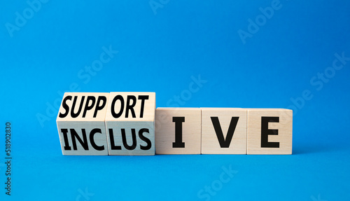 Supportive and Inclusive symbol. Turned wooden cubes with words Inclusive and Supportive. Beautiful blue background. Business, psychological Supportive and Inclusive concept. Copy space